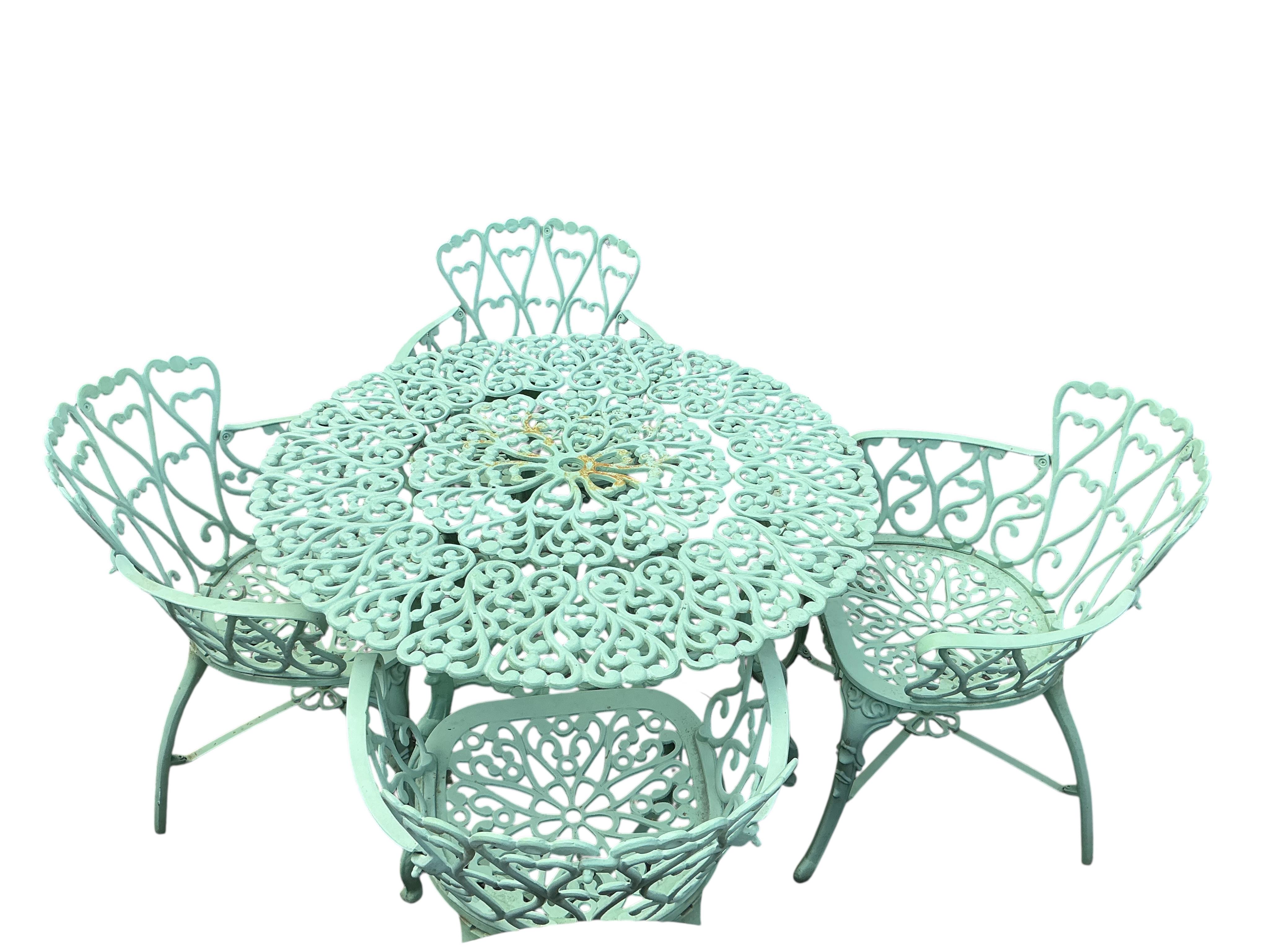 A painted circular aluminium garden table and four chairs, table diameter 99cm, height 69cm